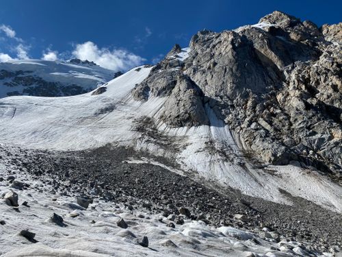 Free Breathtaking view of a snow-capped mountain with rugged rock formations under a clear blue sky. Stock Photo