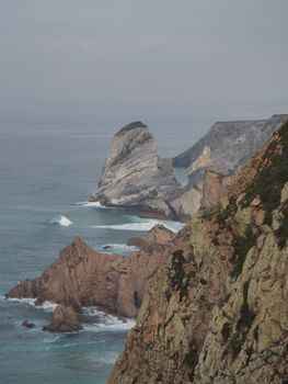 Explore the stunning rock formations and ocean waves along the Colares coastline in Portugal.