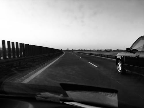 Grayscale Photography of Car on Road