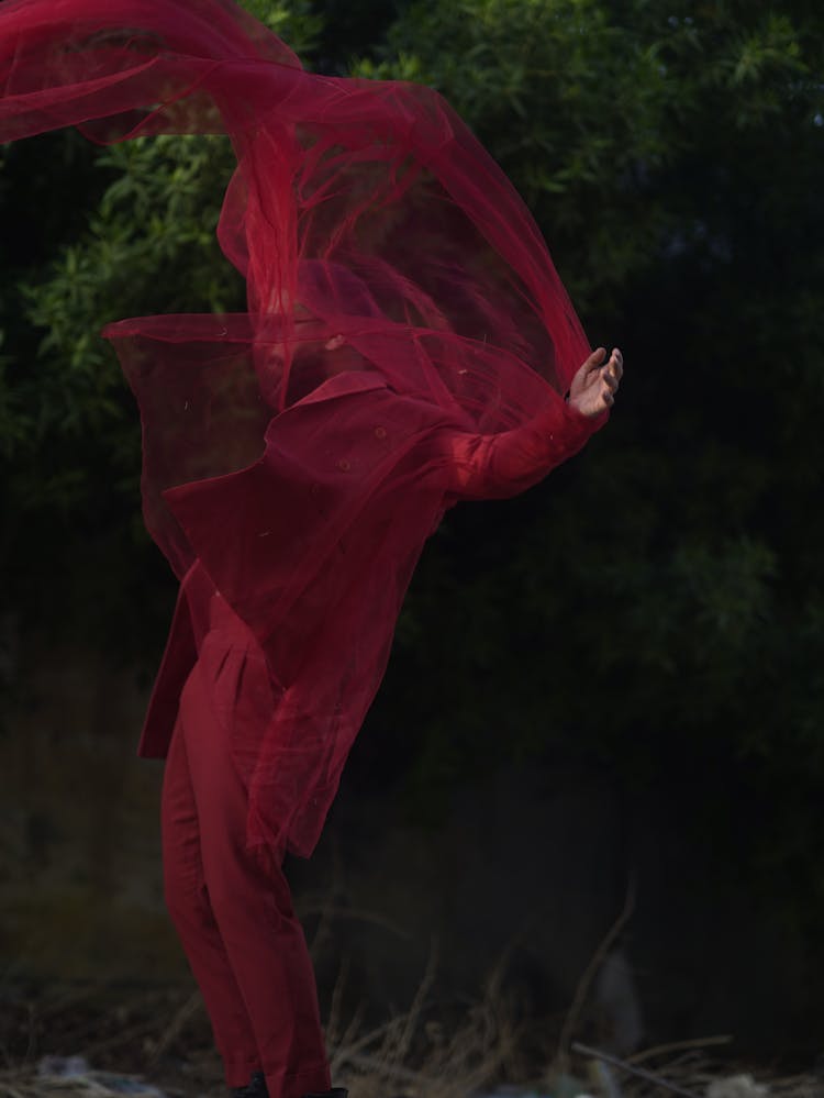 Red Fabric Covering The Person In Rec Suit