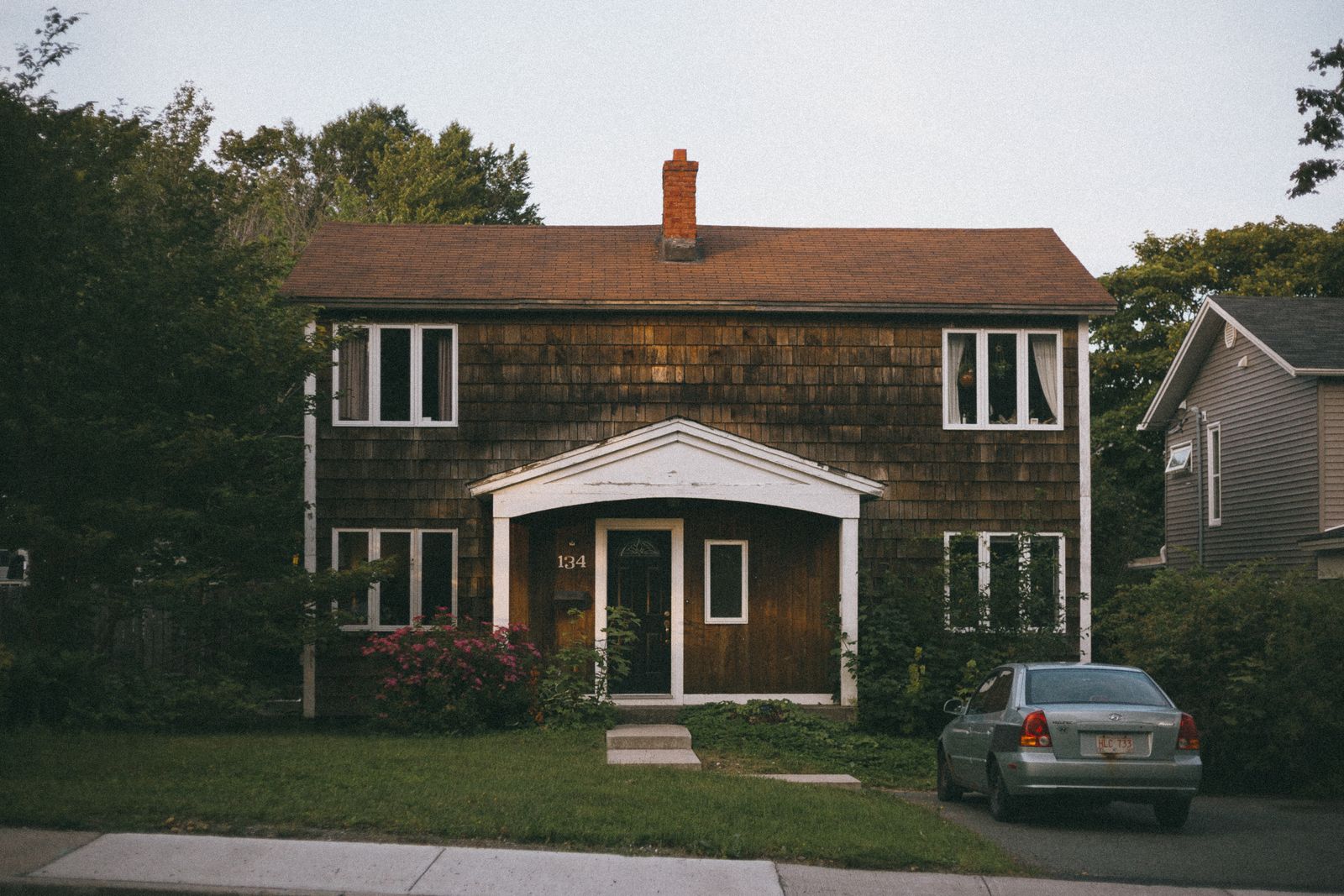 Two-storey suburban house with a parked car