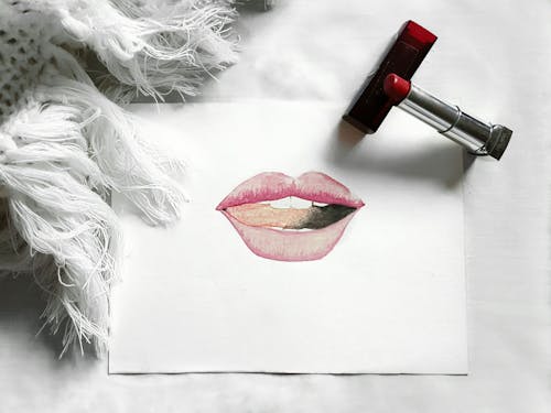 Lips Drawing and Lipstick on White Background