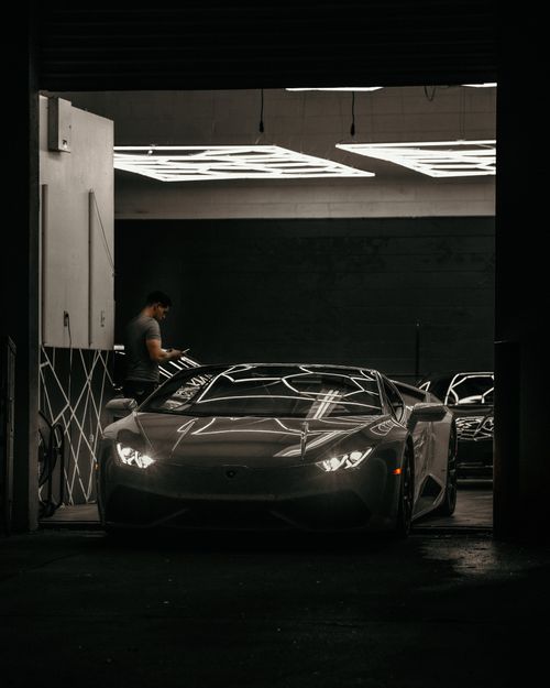 Free Sleek Lamborghini Aventador parked in a sophisticated modern garage, showcasing luxury design. Stock Photo