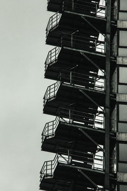 Free High-rise industrial staircase in monochrome, showcasing architectural design. Stock Photo