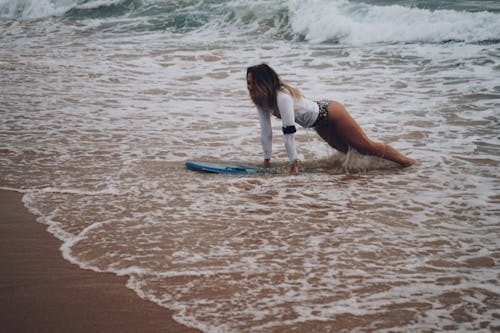 Woman riding Surfboard