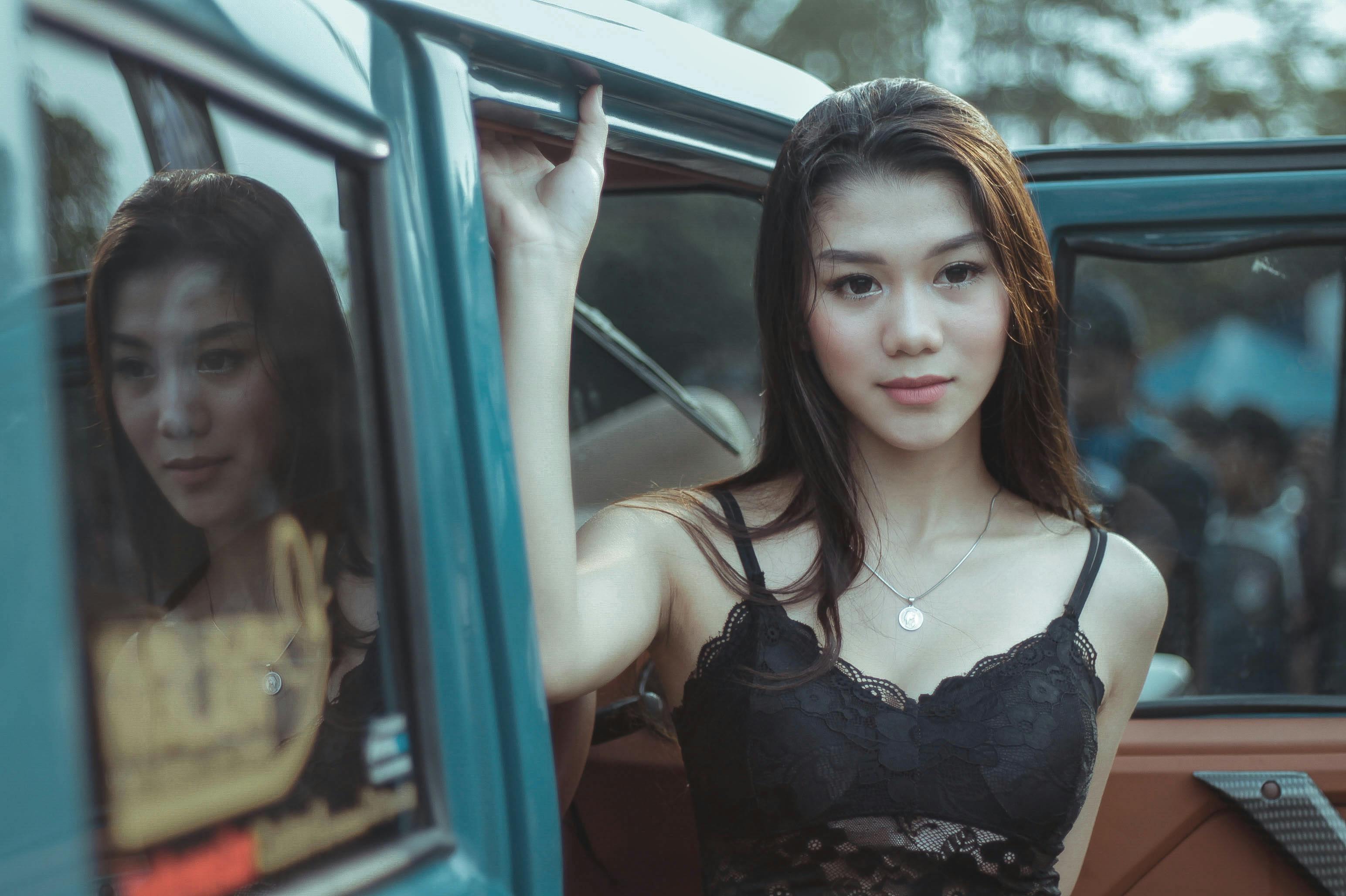 Woman Wearing Lace Tank Top Holding a Car Door
