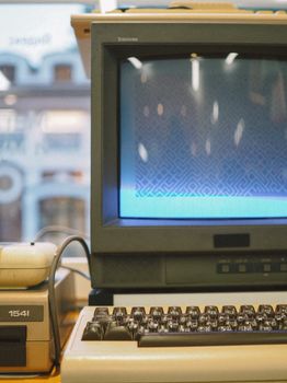 Retro computing setup with a vintage CRT monitor, keyboard, and hardware, showcasing nostalgia.