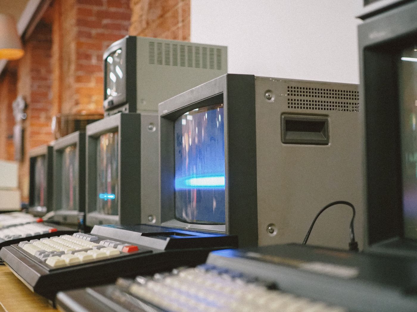 A row of vintage CRT terminals and keyboards — photo by Viktorya Sergeeva on Pexels