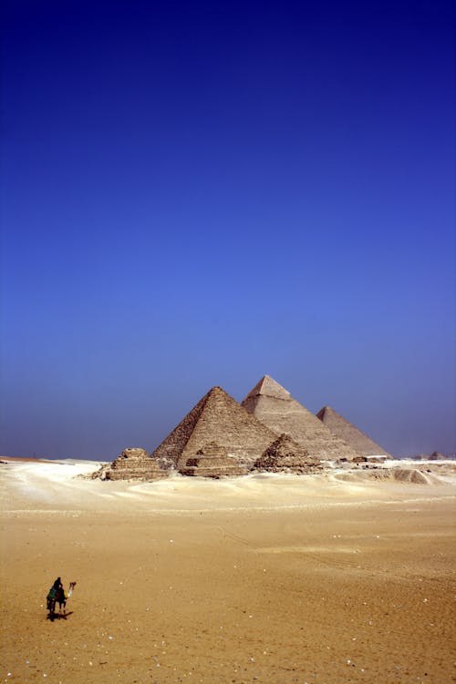 бесплатная Серые бетонные пирамиды посреди пустыни днем Стоковое фото