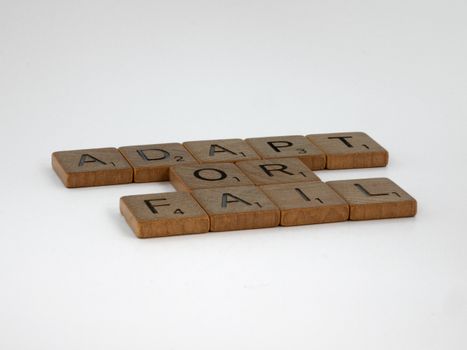 Scrabble tiles spelling 'Adapt or Fail' on a plain background, symbolizing decision-making.