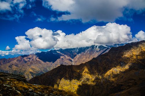 Free Stunning mountain scenery with dramatic clouds casting shadows. Stock Photo