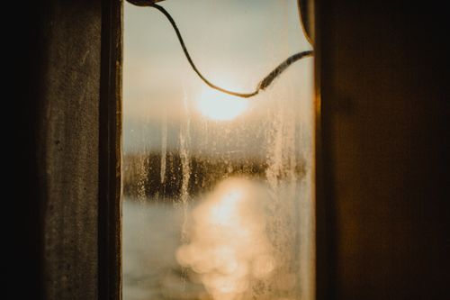 Free Captivating view through a rustic window, showcasing a serene sunset over Istanbul. Stock Photo