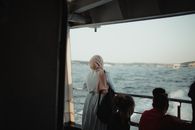 Woman in White Hijab Sitting on Boat