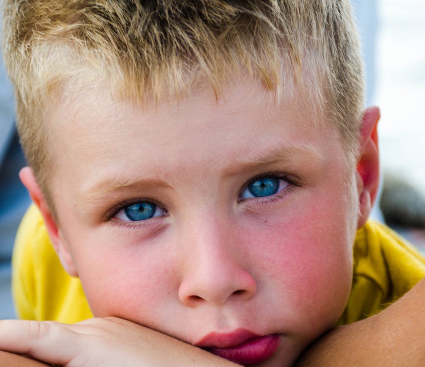 Free Close-Up Photography of Boy With Blue Eyes Stock Photo