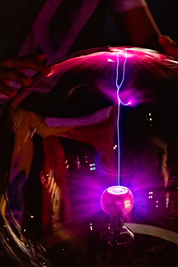 A Person Holding A Plasma Ball