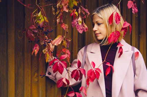 Blonde Woman Touching Leaves