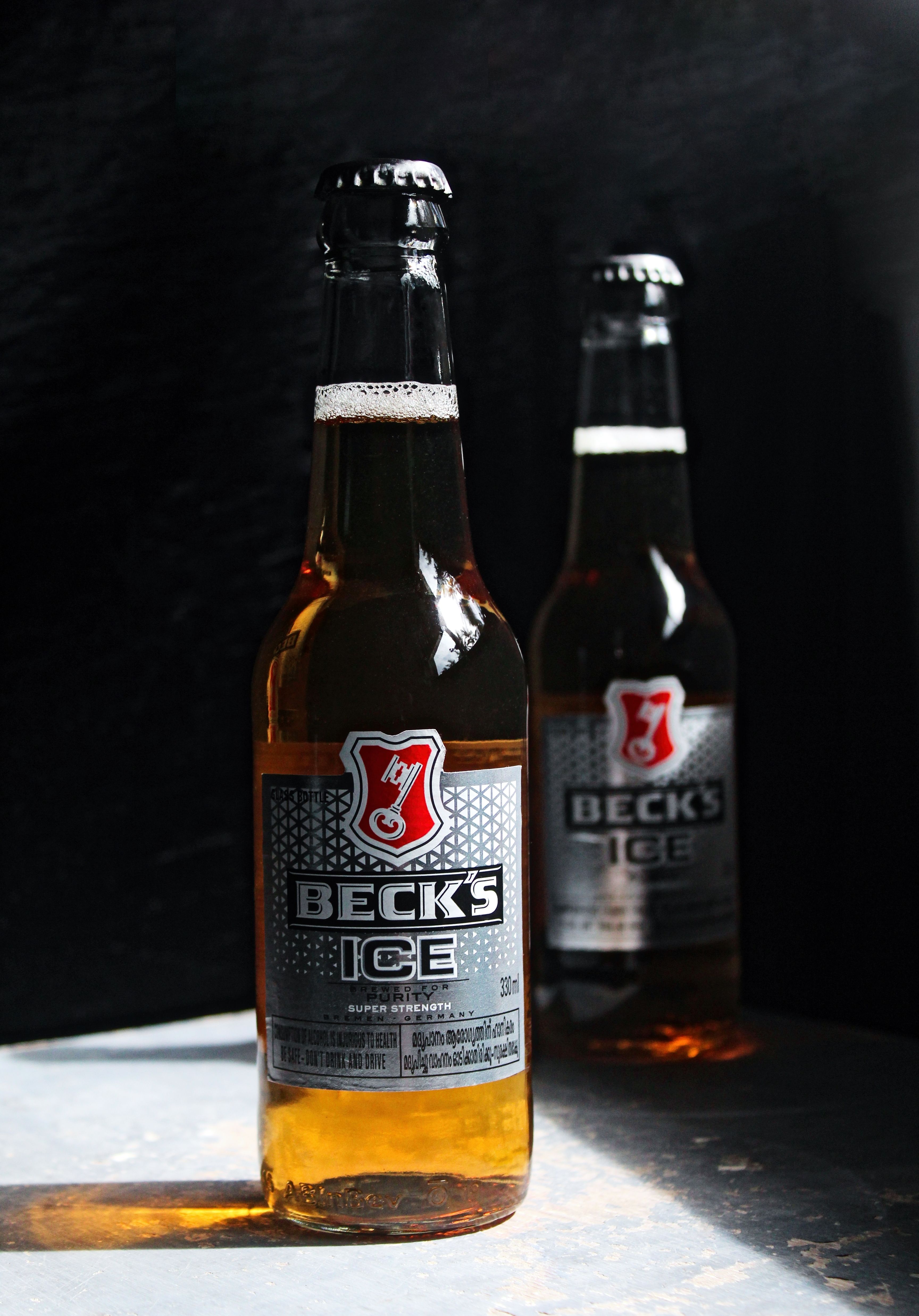 Close-up shot of Beck's Ice beer bottles with dramatic lighting, perfect for advertising and product promotions.