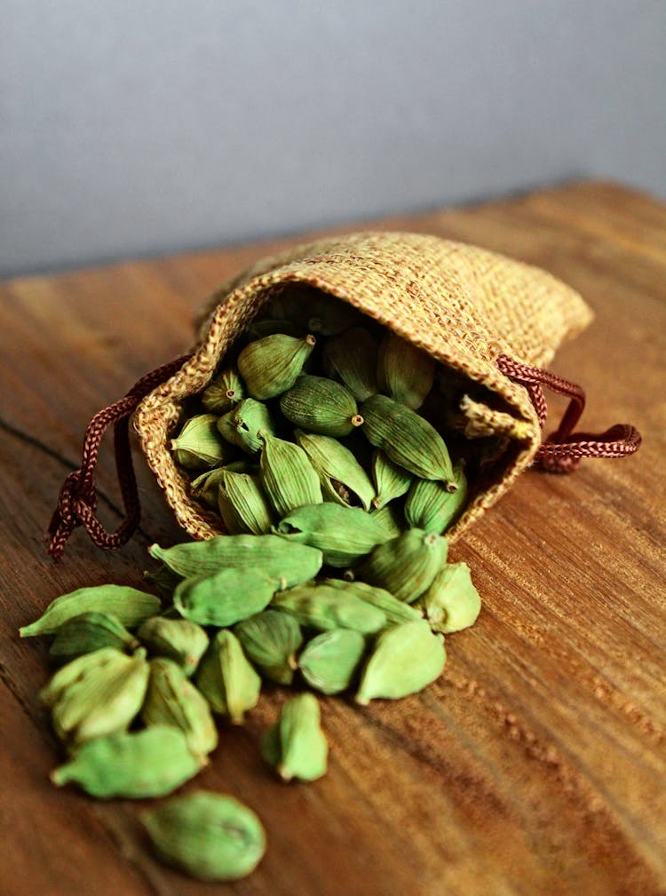 Cardamom Pods On Wooden Table