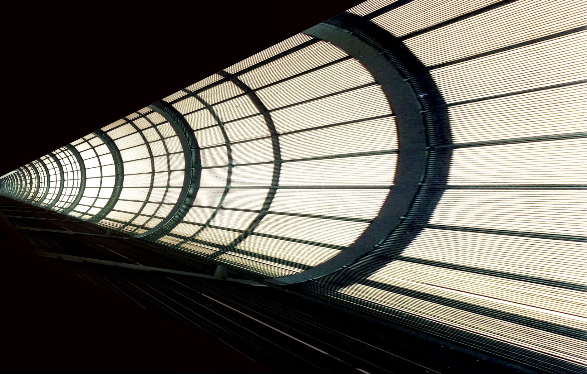 A modern, abstract view of a metallic tunnel with illuminated grids.
