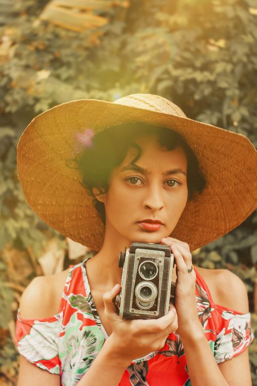 Free Portrait of a young woman outdoors in Rio with a vintage camera. Stock Photo