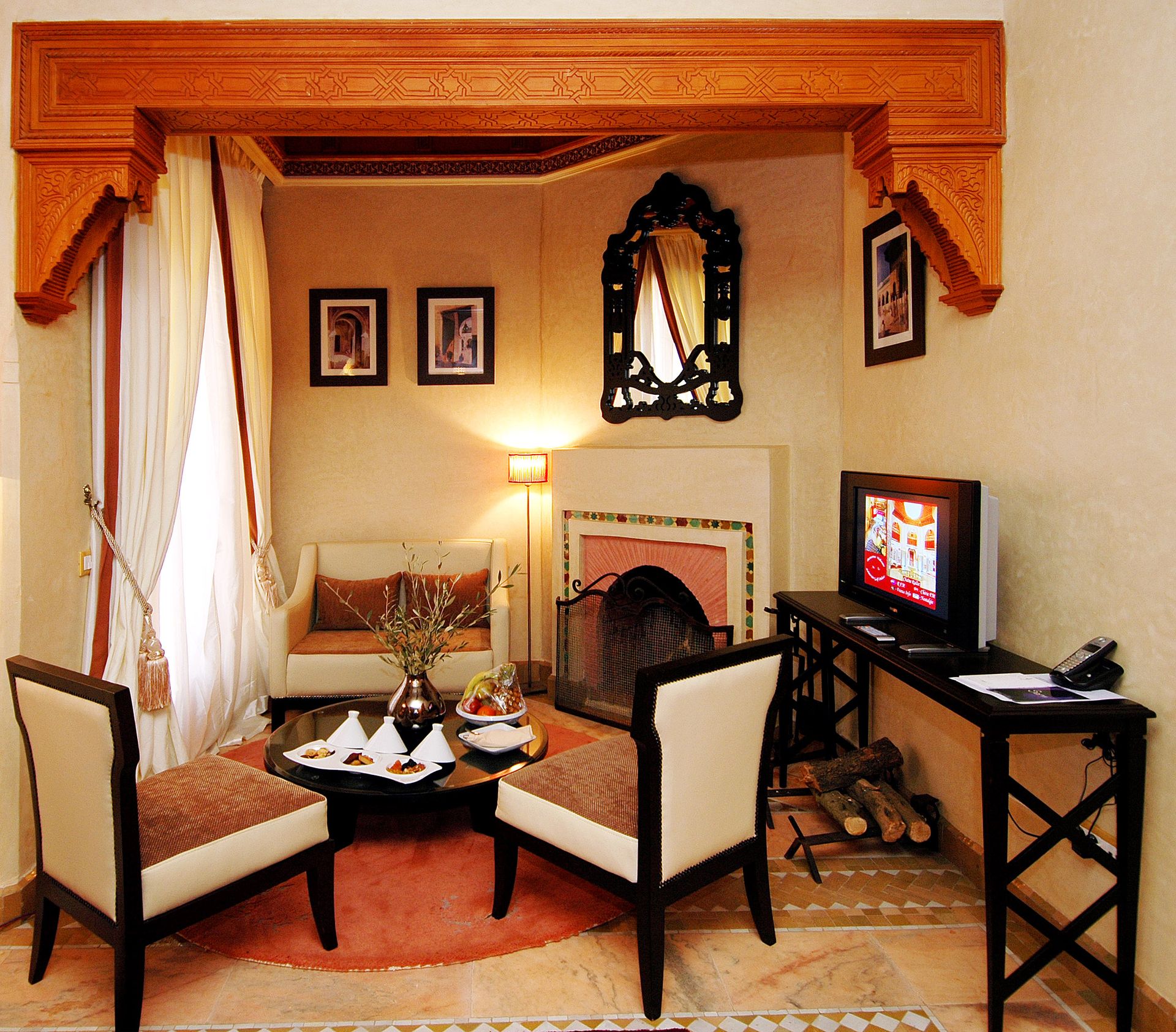 Warm and inviting Moroccan interior with fireplace and traditional decor.