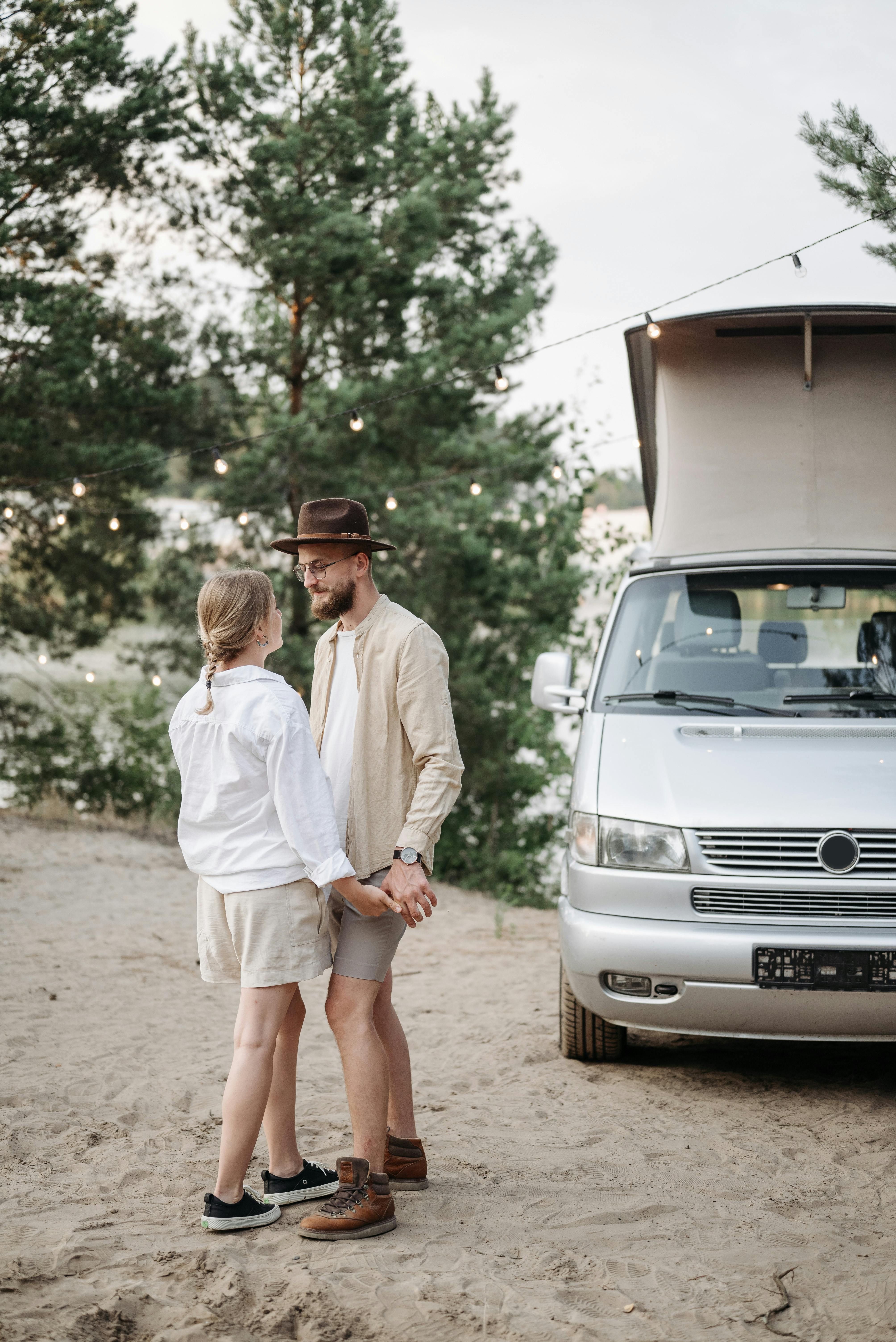 a couple standing beside the campervan