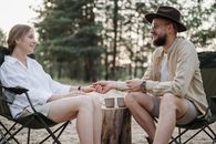 Man in White Dress Shirt Sitting on Brown Wooden Bench