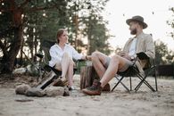 A Couple Sitting on Folding Chairs while Having Conversation