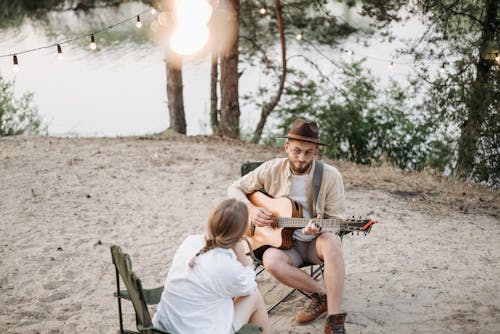 Man Playing Guitar For Woman