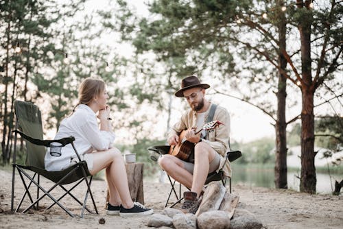 Man Playing a Guitar Sitting with a Woman