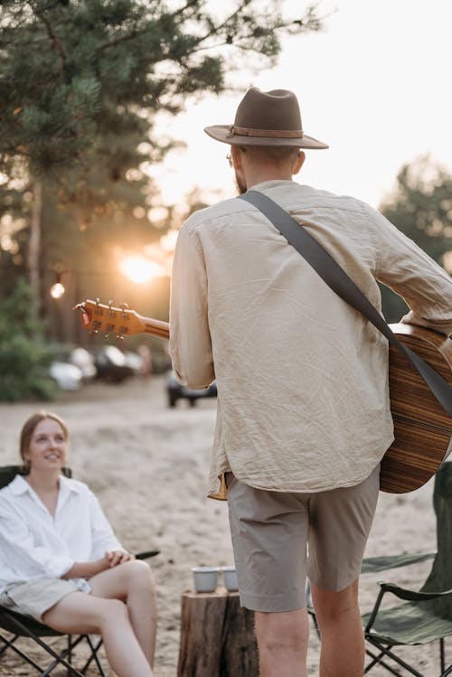 Man Playing a Guitar for a Woman