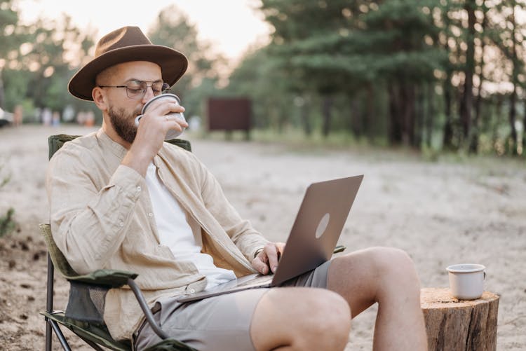 Man Drinking From A Cup