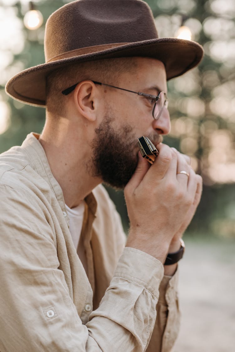 A Bearded Man Playing Harmonica