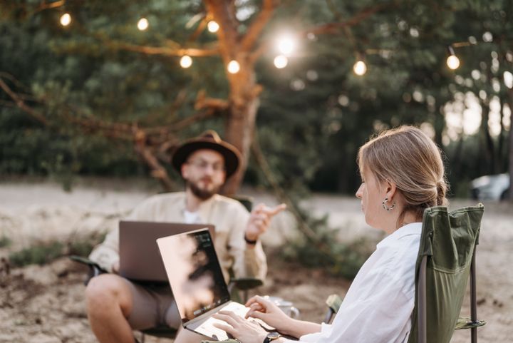 Two people working remotely with laptops outdoors — Pavel Danilyuk on Pexels