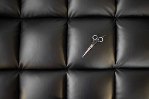 Free Photo of Scissor on Black Leather Cushion Stock Photo