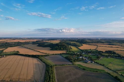 Free A breathtaking aerial view of the rural countryside in Bedfordshire, England, showcasing serene fields and rolling hills. Stock Photo