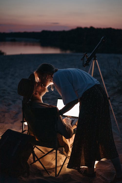 Couple Kissing while Camping on a Beach 