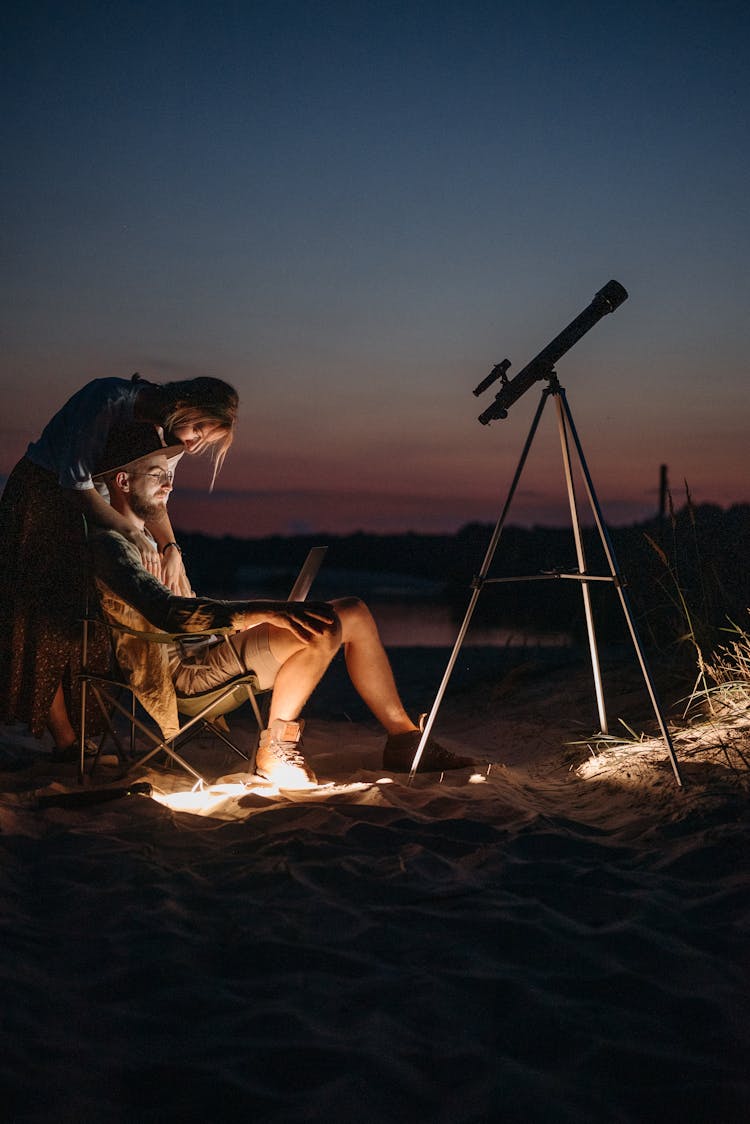 A Man Using A Laptop At Night