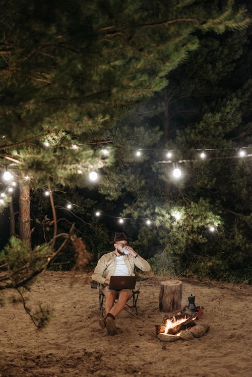 A Man Sitting Beside the Campfire