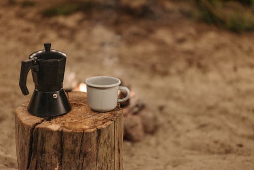Free A Ceramic Cup on a Wooden Log Stock Photo