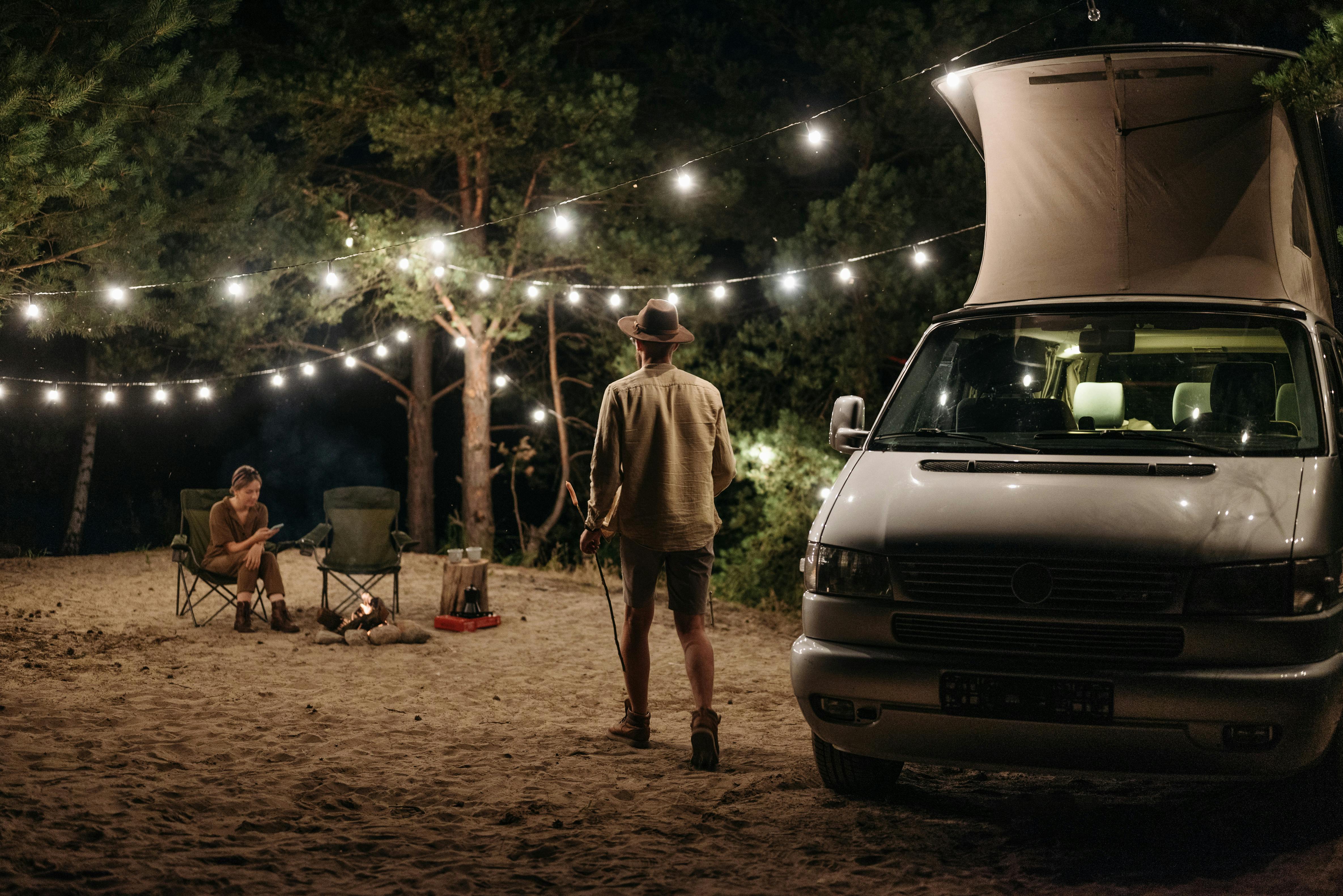 a man standing beside the campervan