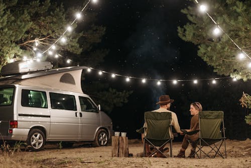 Couple Sitting on Camping Chairs