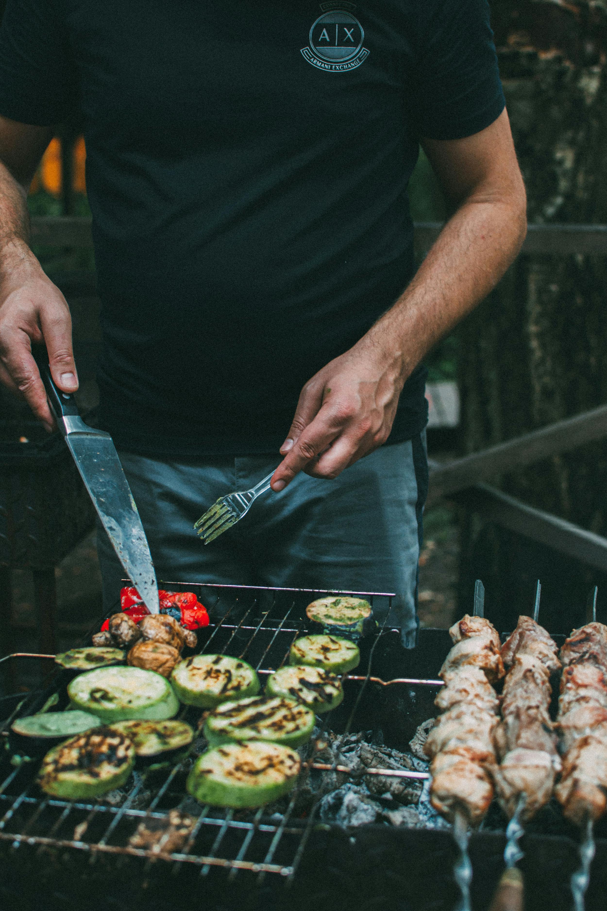 Man with Knife and Fork Grilling Free Stock Photo