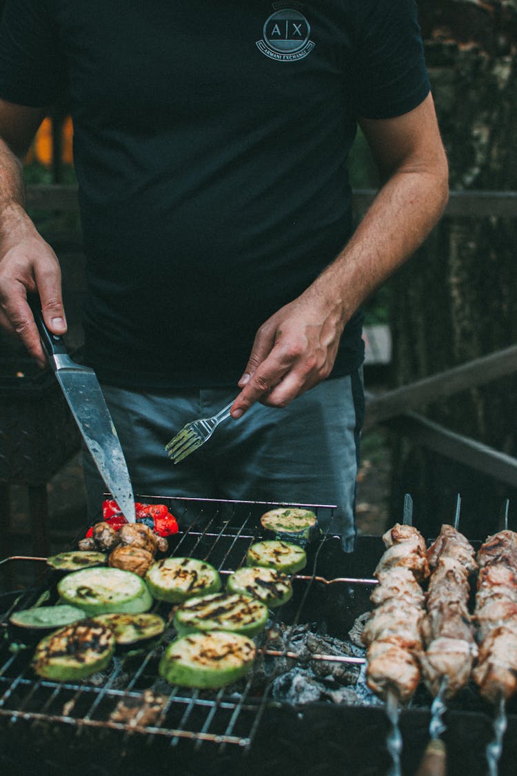 Man With Knife And Fork Grilling