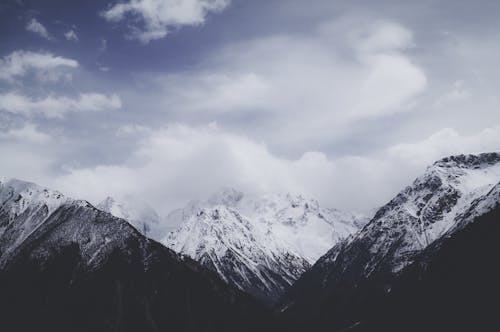 A Snow Covered Mountain Under the Cloudy Sky