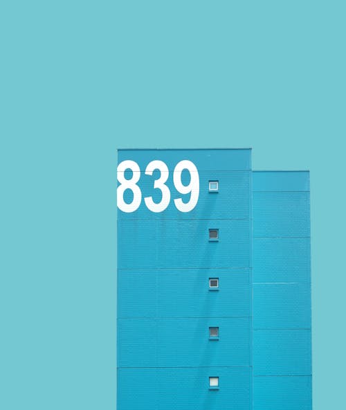Free A Blue Brick Building with Numbers and Windows Stock Photo