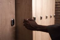 Person Holding Brown Wooden Door