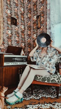 Woman in a retro living room holding a vinyl record with a vintage turntable setup.