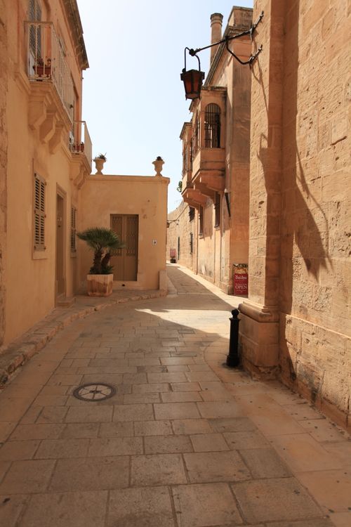 Free Explore the sunlit streets of Mdina, Malta, showcasing charming limestone architecture. Stock Photo