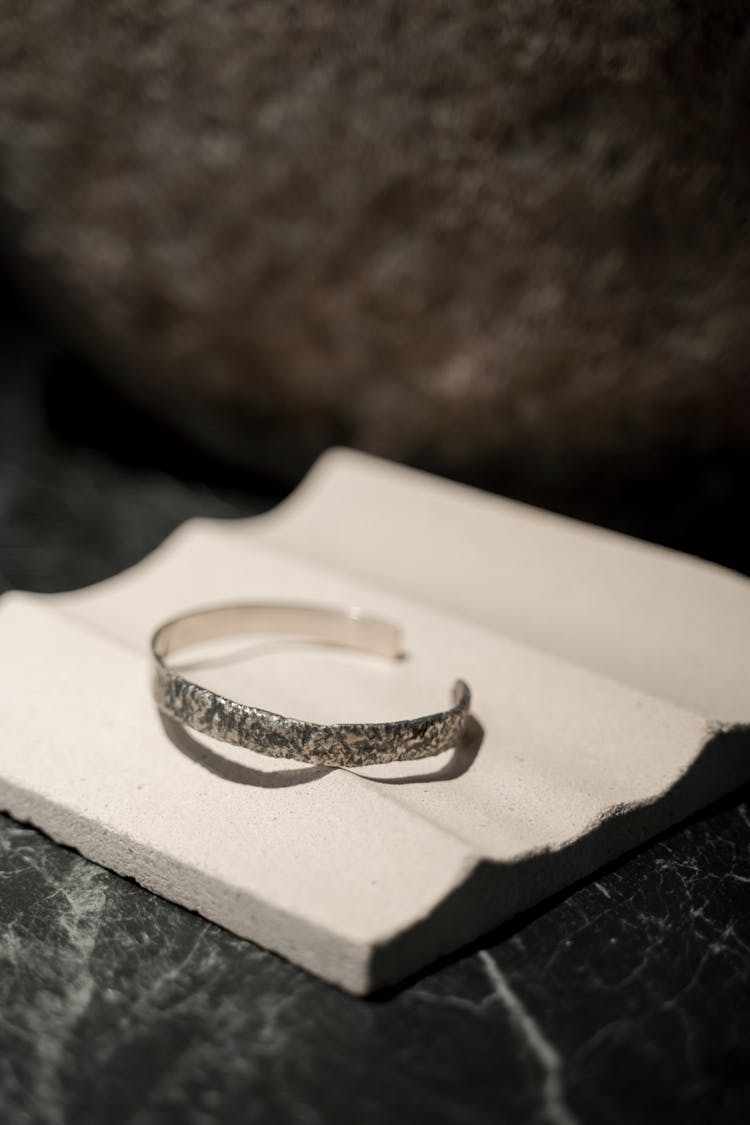 Silver Bangle On White Surface